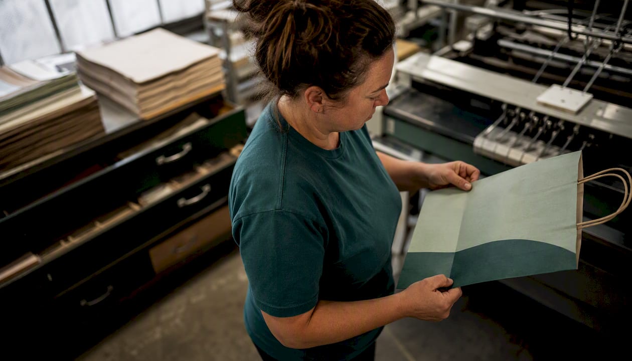 Worker inspecting eco-friendly paper bags