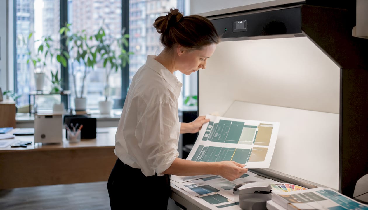 Quality control specialist inspecting printed packaging colors
