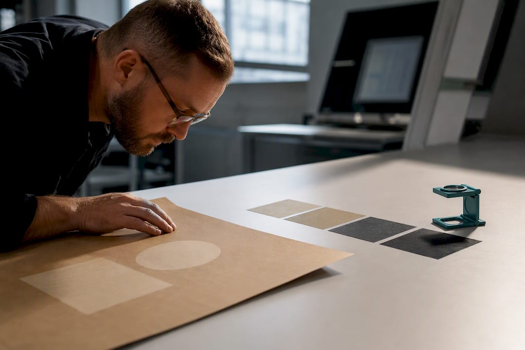 Technician examining printed ink coverage samples